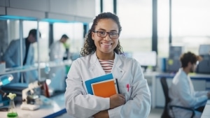 Medical student with glasses standing in a computer lab