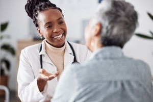 African-American professional speaking with a patient